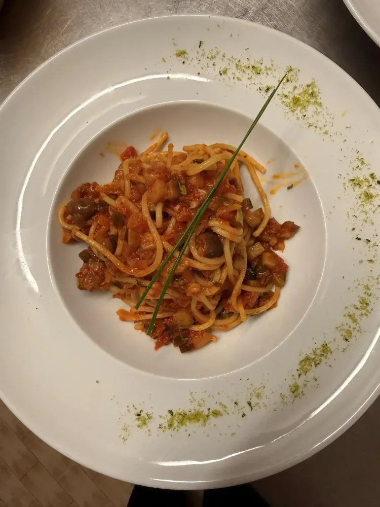 House-made pasta with tomato sauce, vegetables, olives and capers